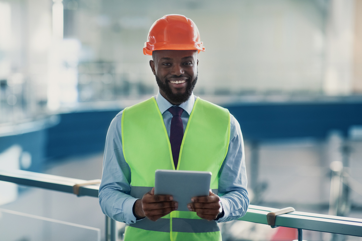 Smiling African American Civil Engineer with Digital Tablet